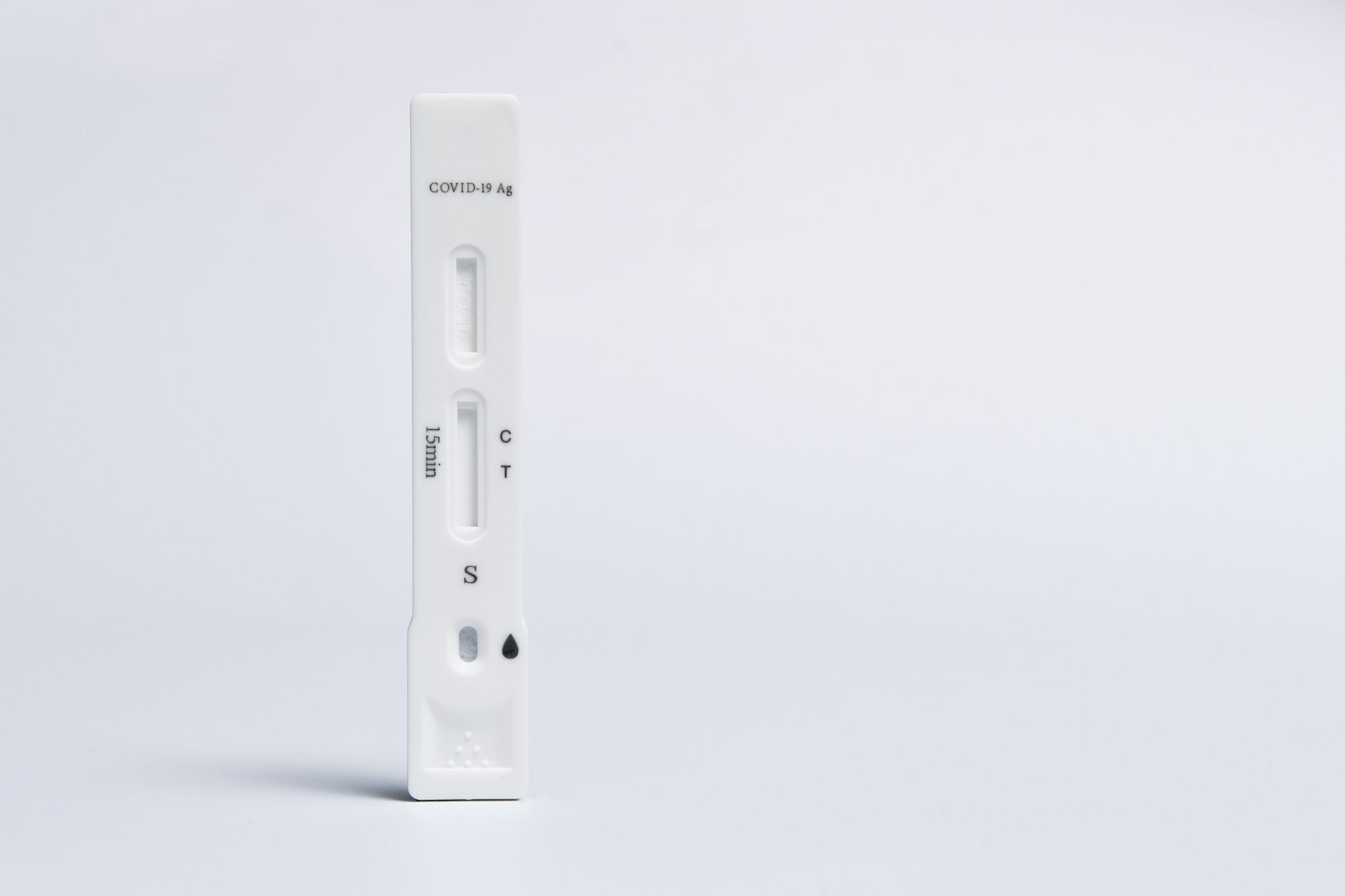 Isolated COVID-19 rapid antigen test on a white background, showing test and control lines.
