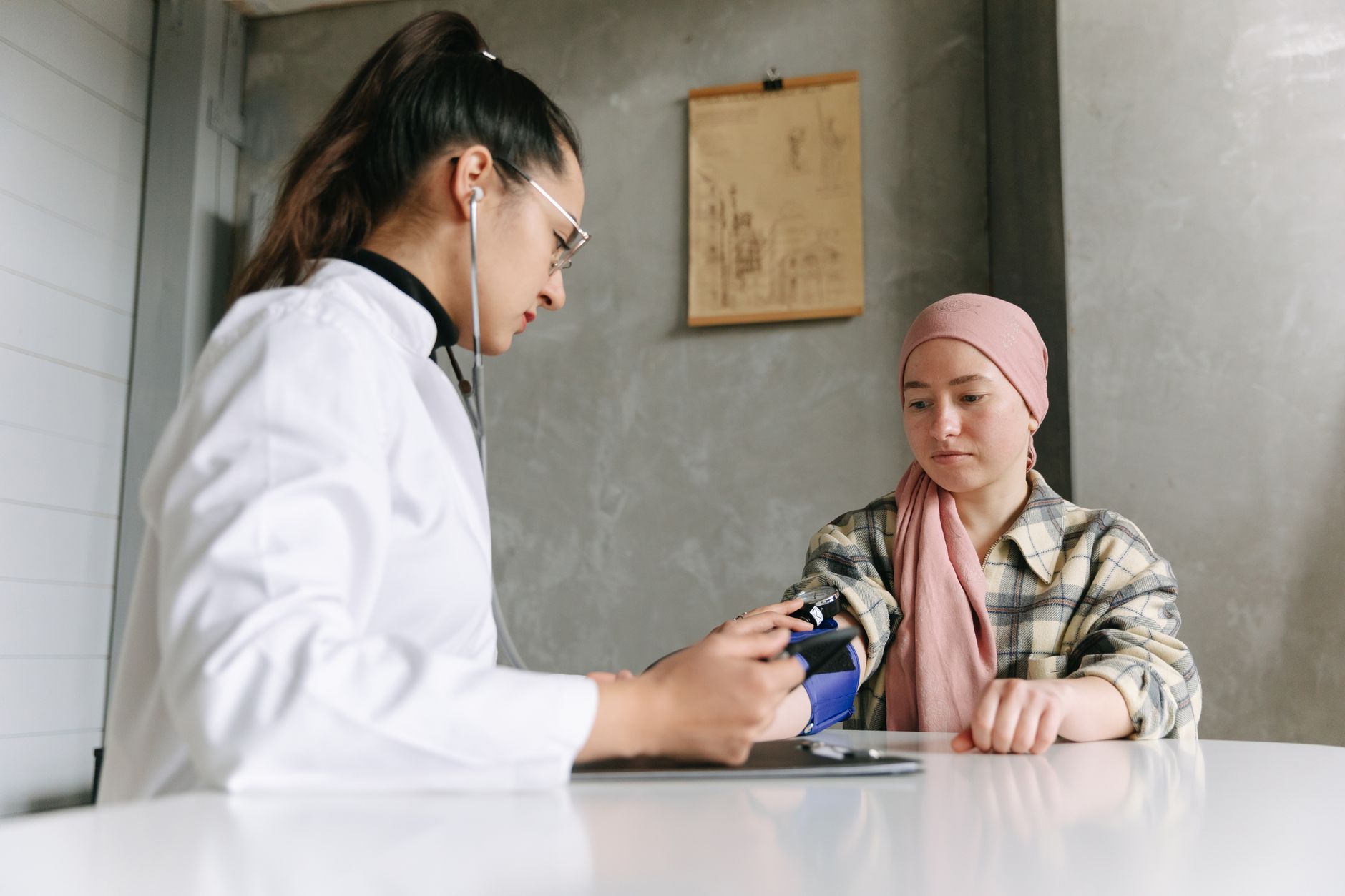 A medical professional checks a patient's blood pressure, depicting a caring healthcare environment.